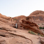 Bride and groom walking on the red sand in Moab Utah