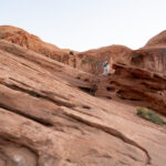 Bride and groom walking on the red sand in Moab Utah