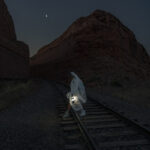 Bride walking at night with a lantern at a Moab Utah Elopement