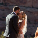 Bride and Groom kiss during sunrise in Moab Utah