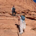 Epic bride and groom hiking the Moab Desert