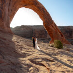 Bride and Groom eloping in golden sunrise light in Utah