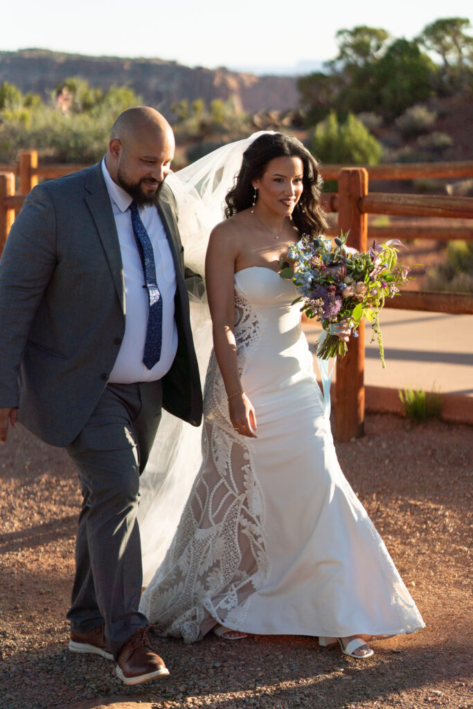 Bride entering the wedding ceremony with a canyon backdrop in Moab Utah