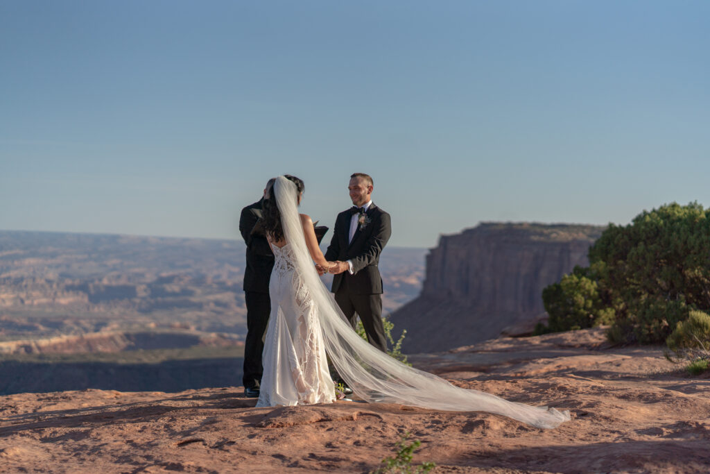Ceremony at overlook in Canyonlands National Park — Sunset vows with canyon backdrop and bilingual officiant.