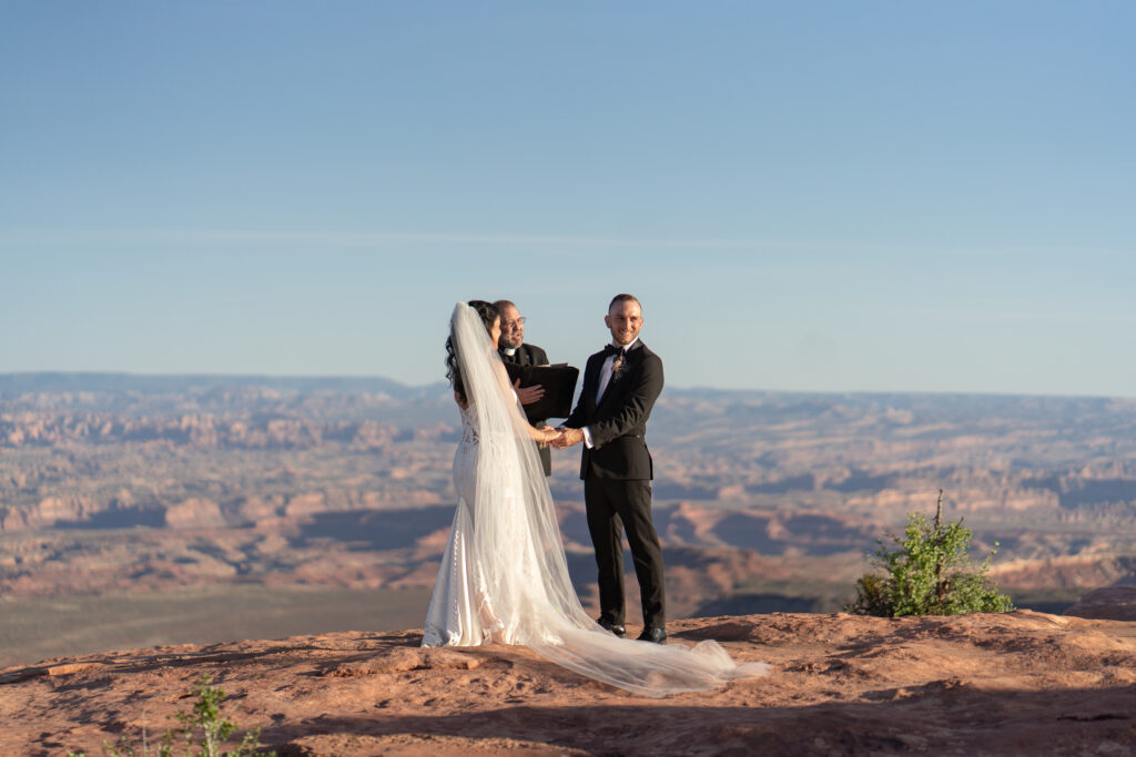 Ceremony at overlook in Canyonlands National Park — Sunset vows with canyon backdrop and bilingual officiant.