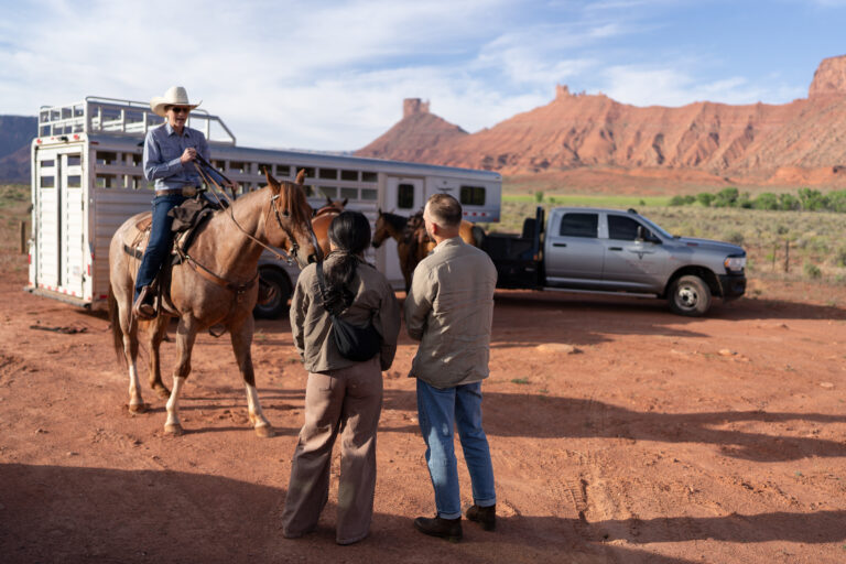 Horseback riding in canyon at sunrise — Couple riding horses through a private canyon trail during their Moab, Utah elopement.