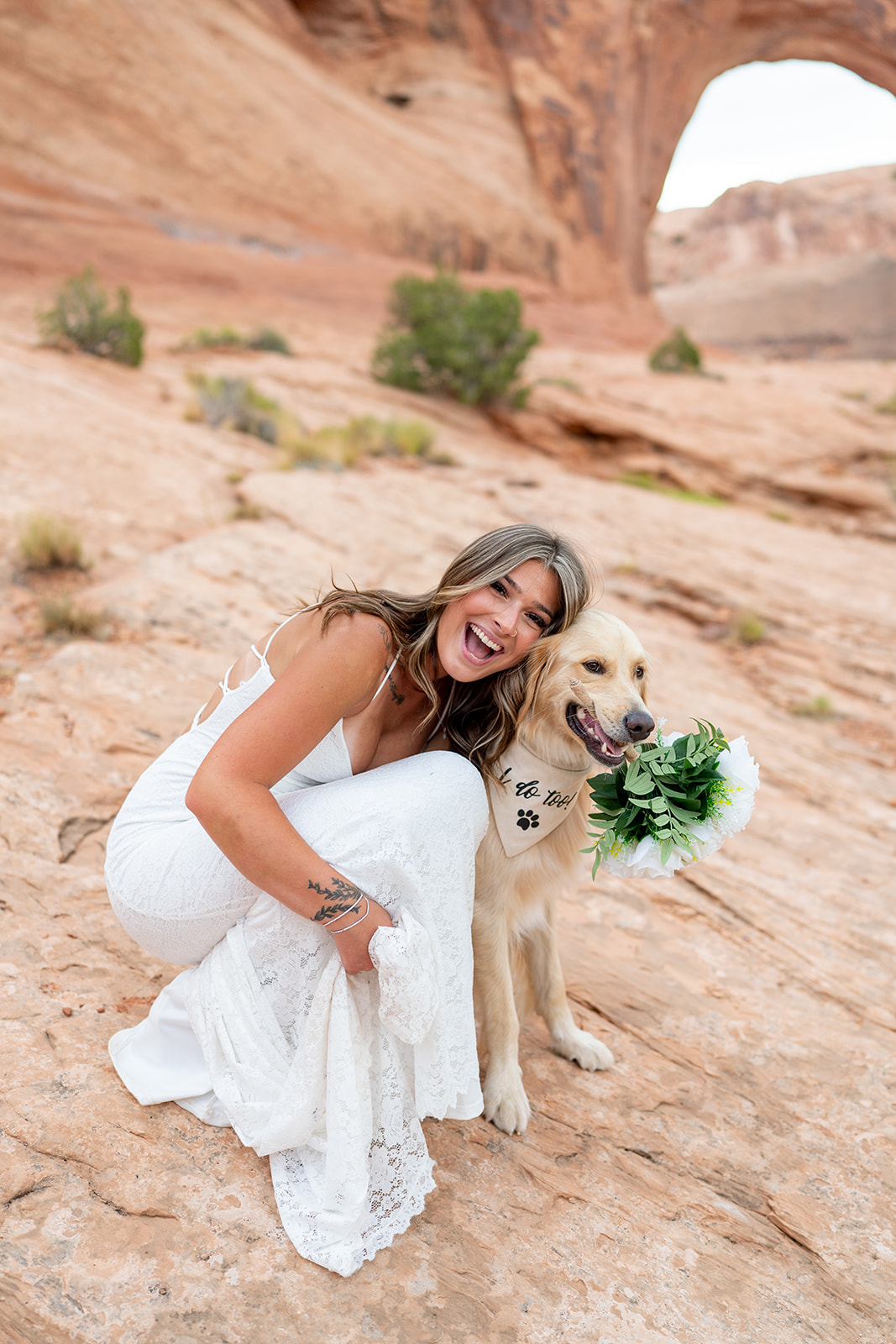 Bride with dog at sunrise during Moab Utah elopement ceremony.