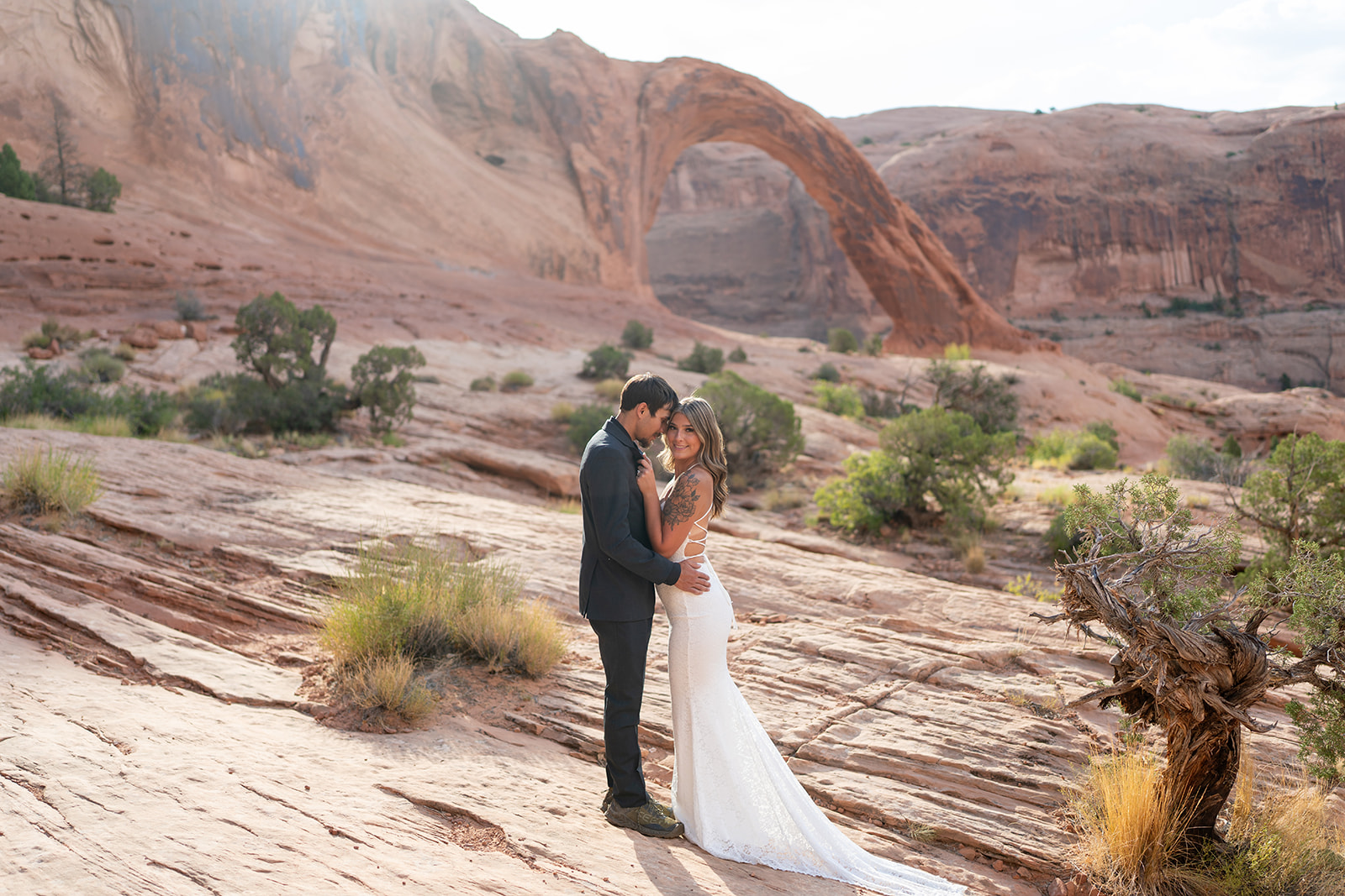 Couple posing in Canyonlands during Moab elopement with marriage license completed