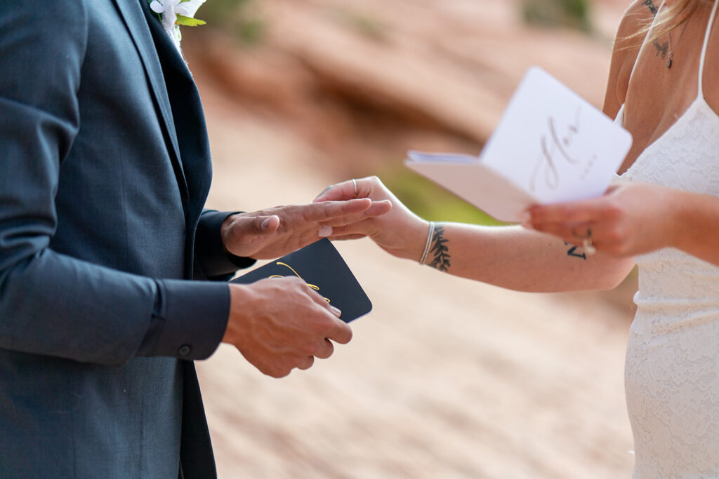 Bride and groom exchanging vows with witnesses at Arches National Park elopement