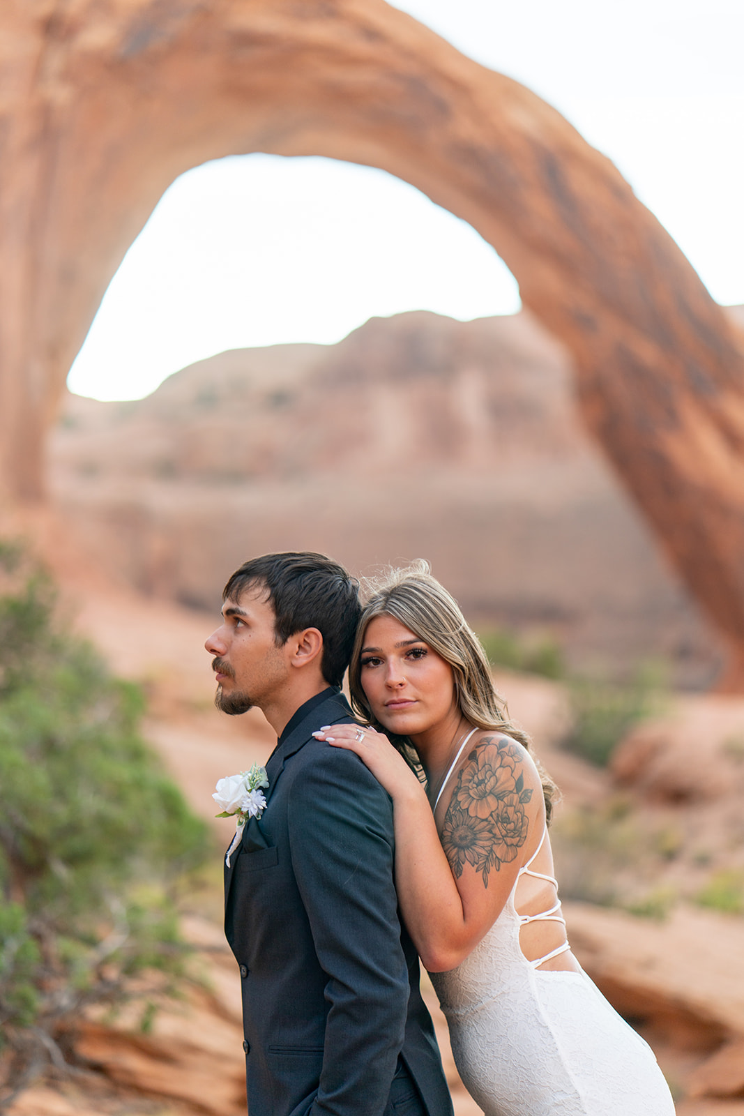Couple posing at sunrise at Arches National Park elopement