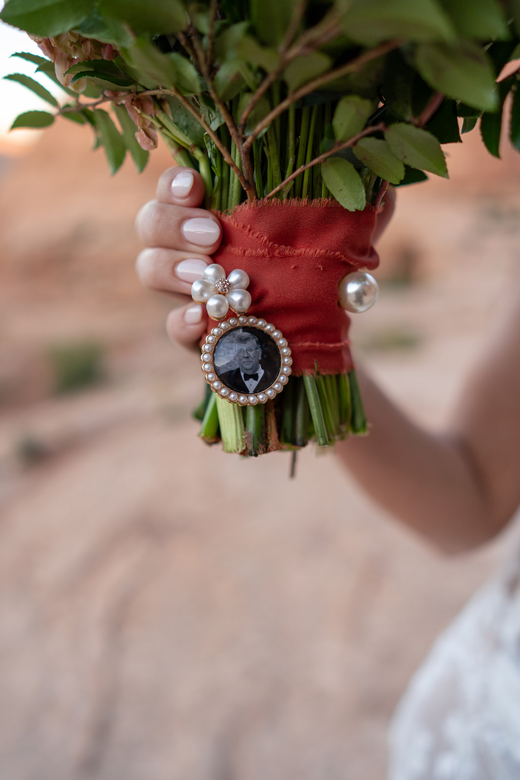Close-up of custom floral arrangement featuring succulents, wildflowers, and roses