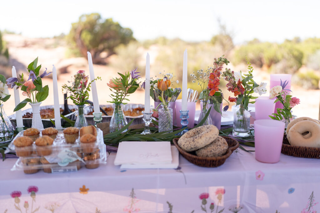Toni of Tangled Sage Event Artistry arranging wedding florals on-site