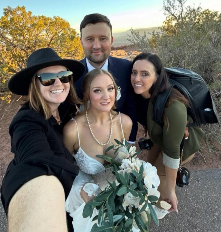 Moab elopement photographer helping couple during ceremony